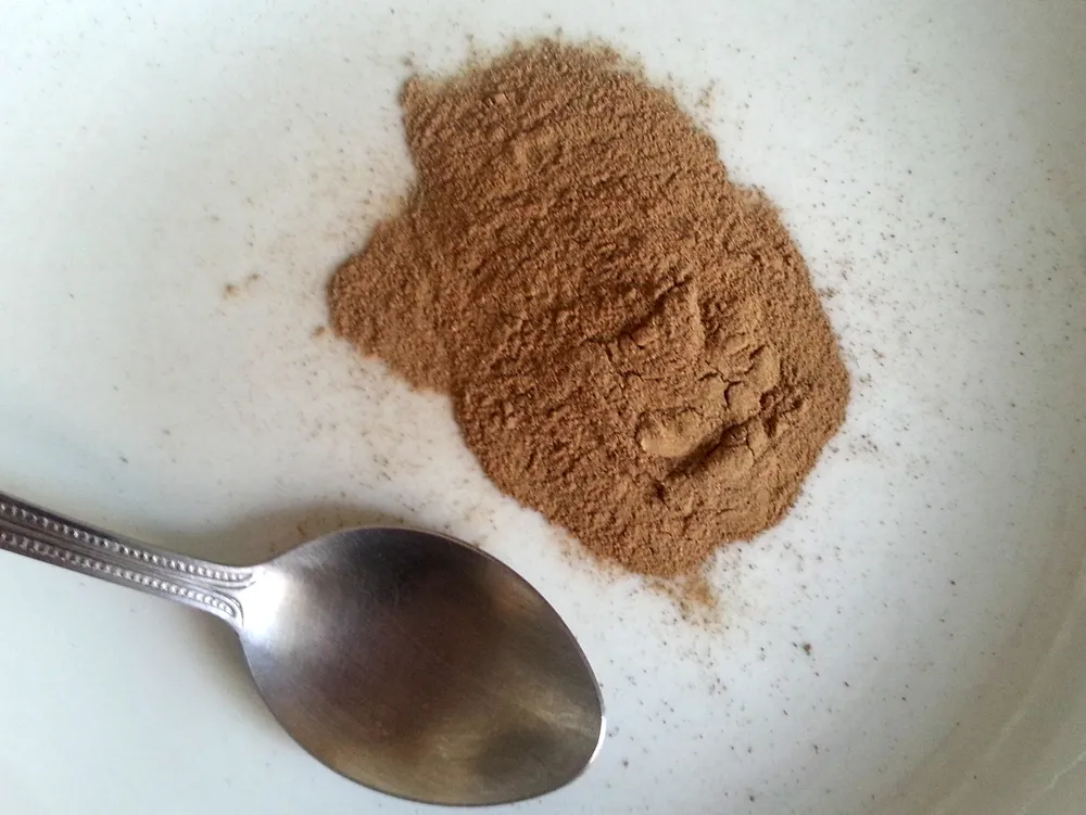 A heap of coarse pale-brown shredded plant fibre, dry and stringy, photographed from above.